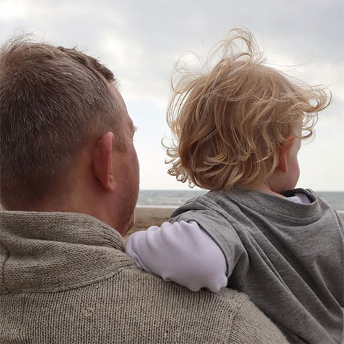 father with a small boy on his arm - wholehearted parenting