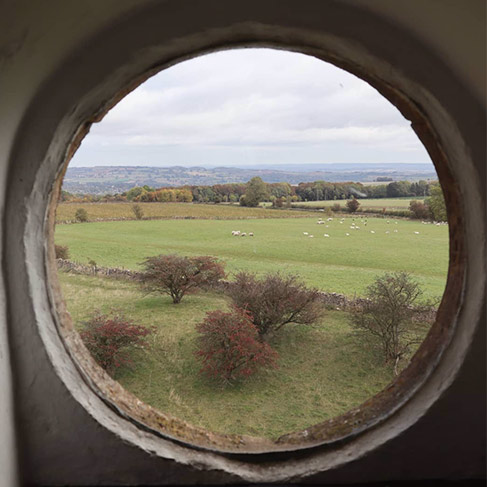 view to countryside scenery through a round window
