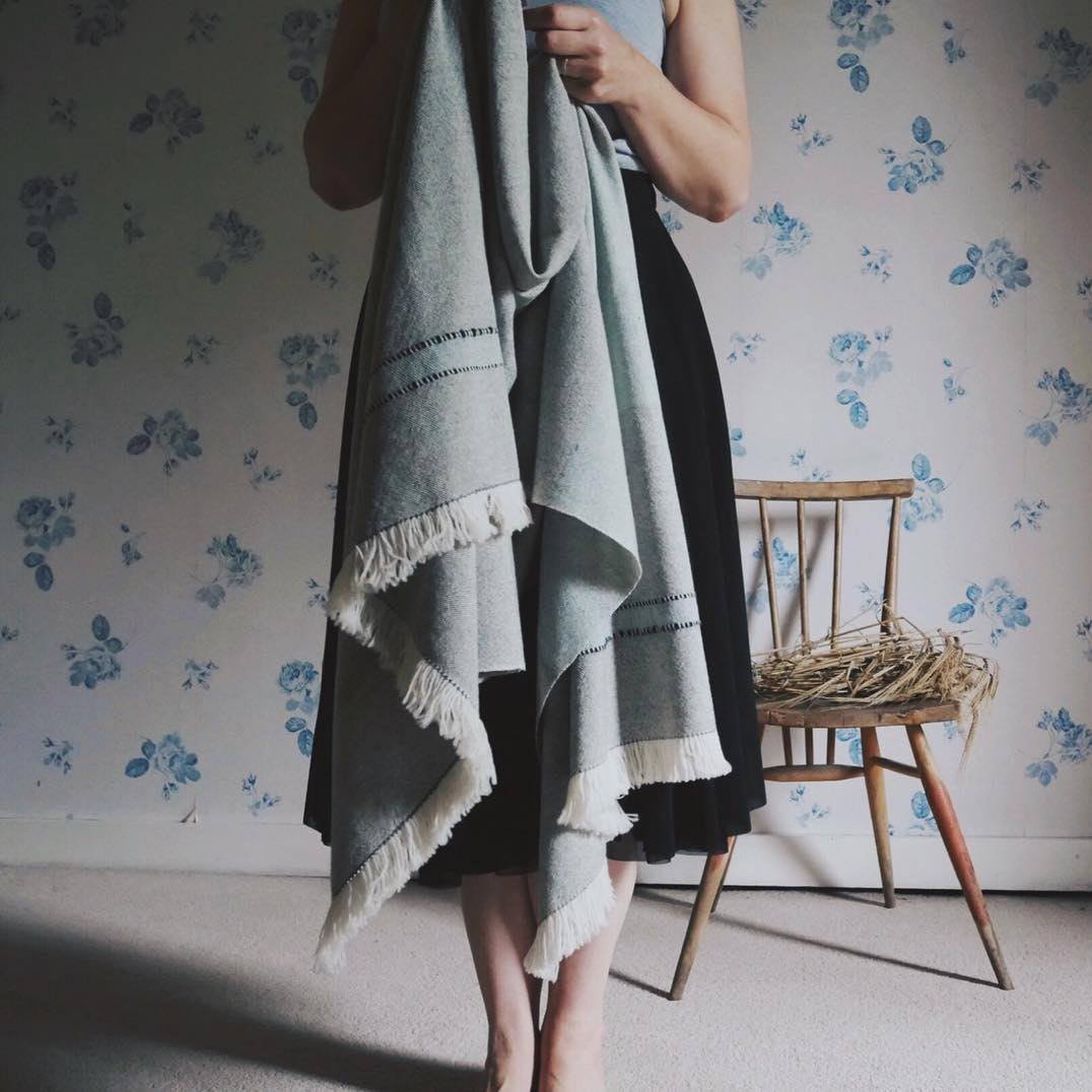 woman holding a blue scarf