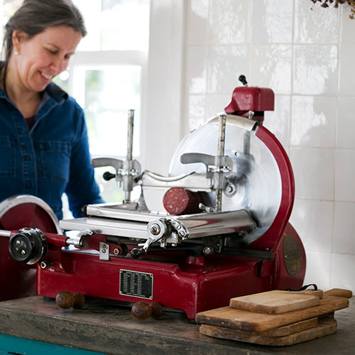 anja from great glen charcuterie slicing salami