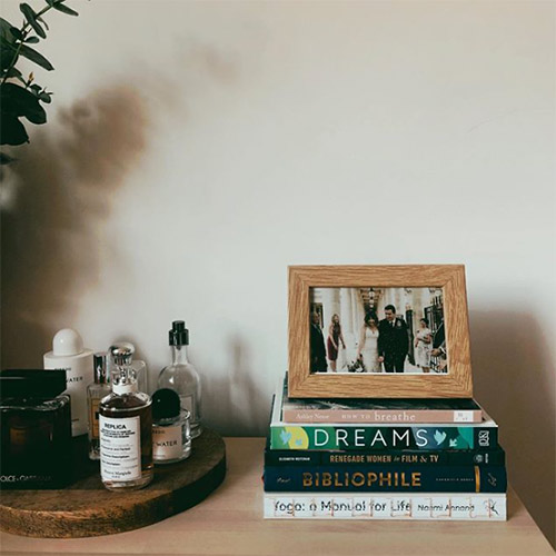 a pile of books and a wedding picture in jen carrington's home