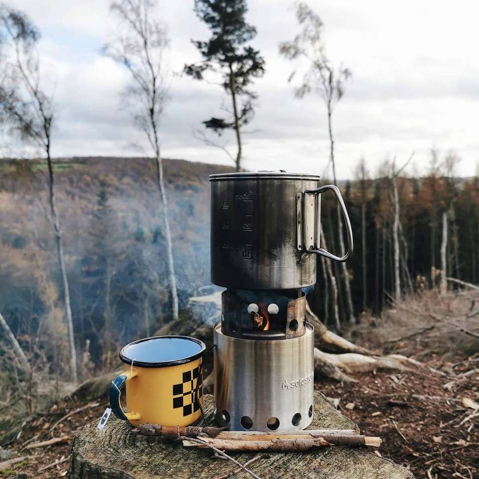 outdoor picnic with a gas burner, kettle and enamel mug 