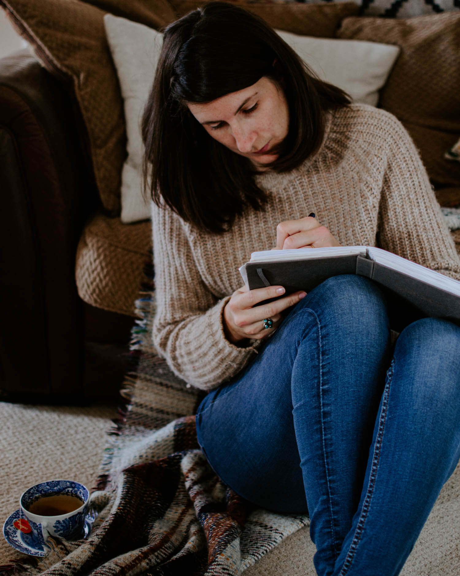 josephine brooks sitting on the floor and journaling