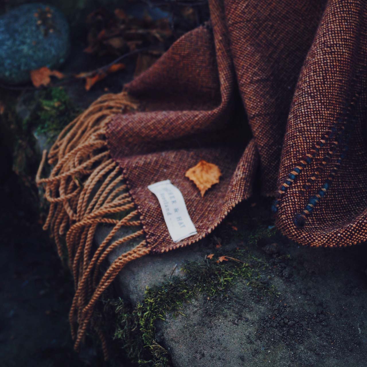 Feather & Hay - shawl a shawl lying on a stone stairway in autumn