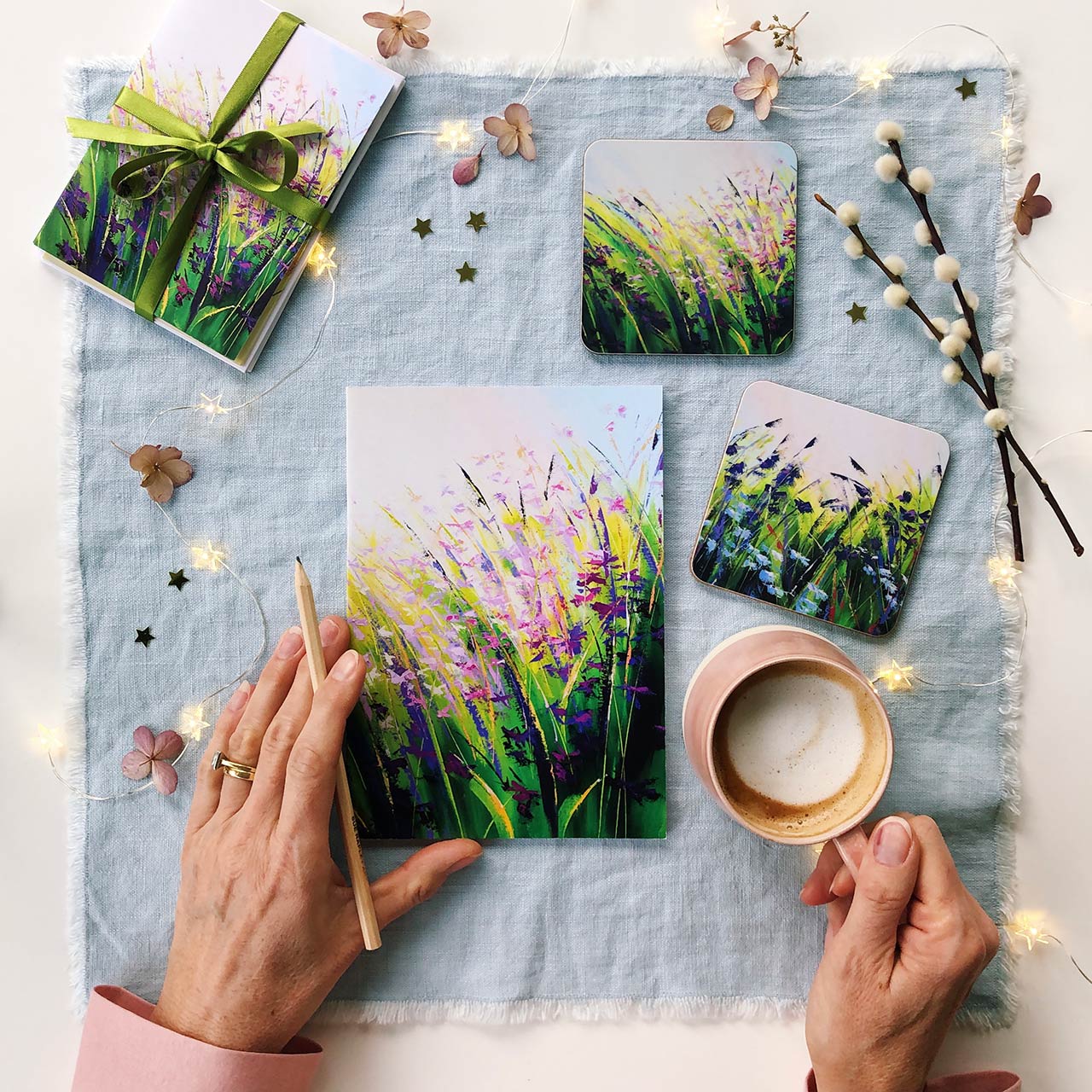 flatlay of gifting items with Sue Rapley Art paintings