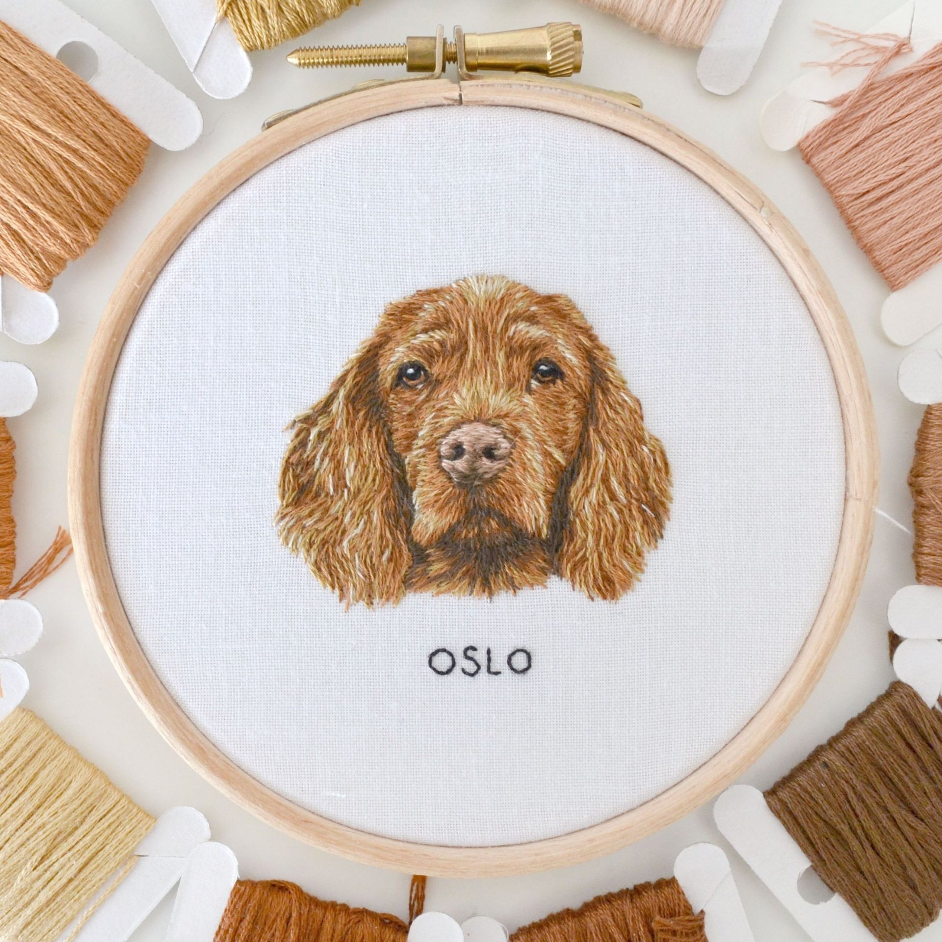 embroidered portrait of a brown dog with the name Oslo