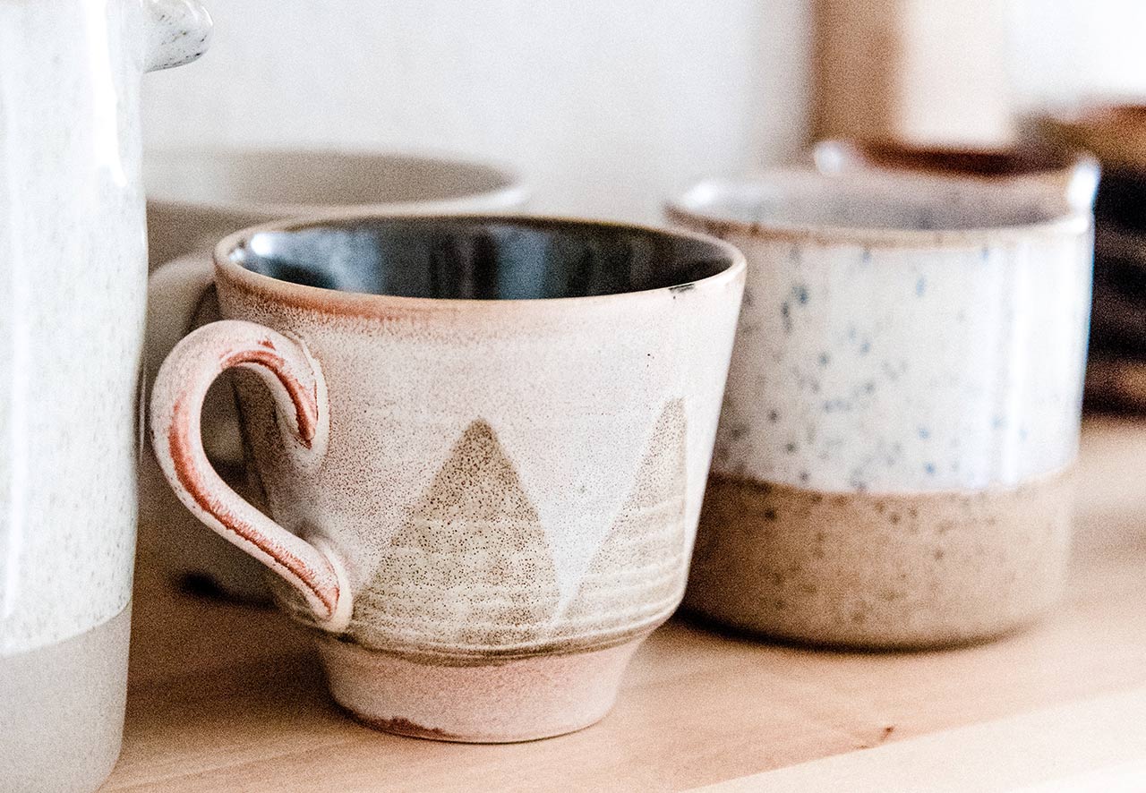 ceramic tea mugs on a shelf