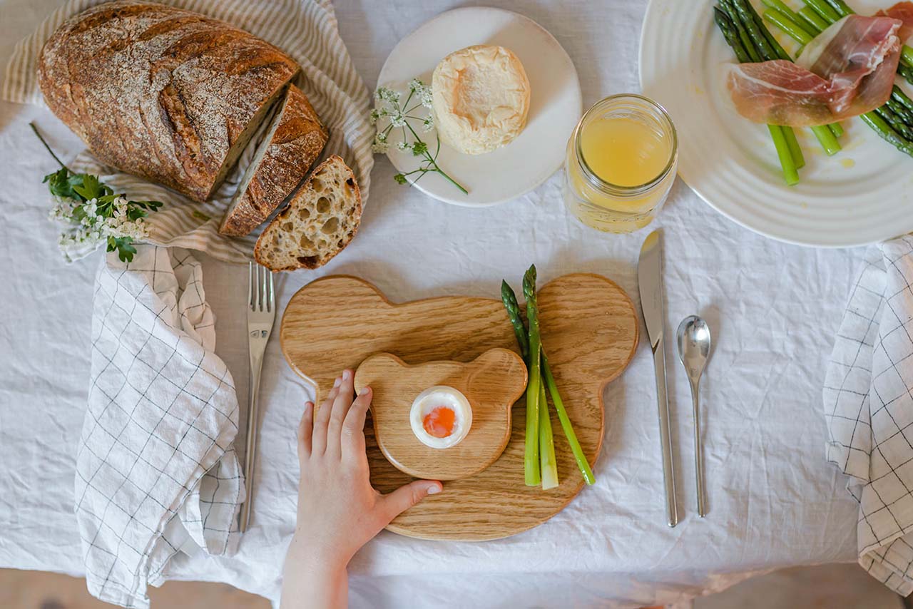 easter breakfast with a wooden bear plate and egg holder