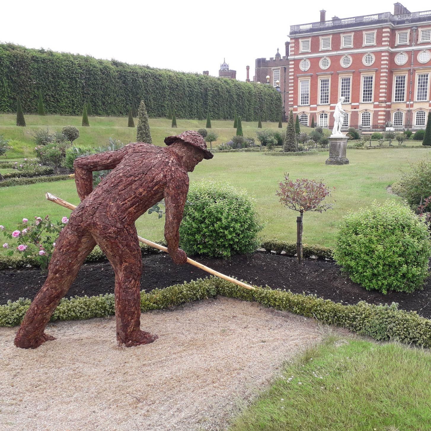 large bark sculpture of gardening man by tessa hayward