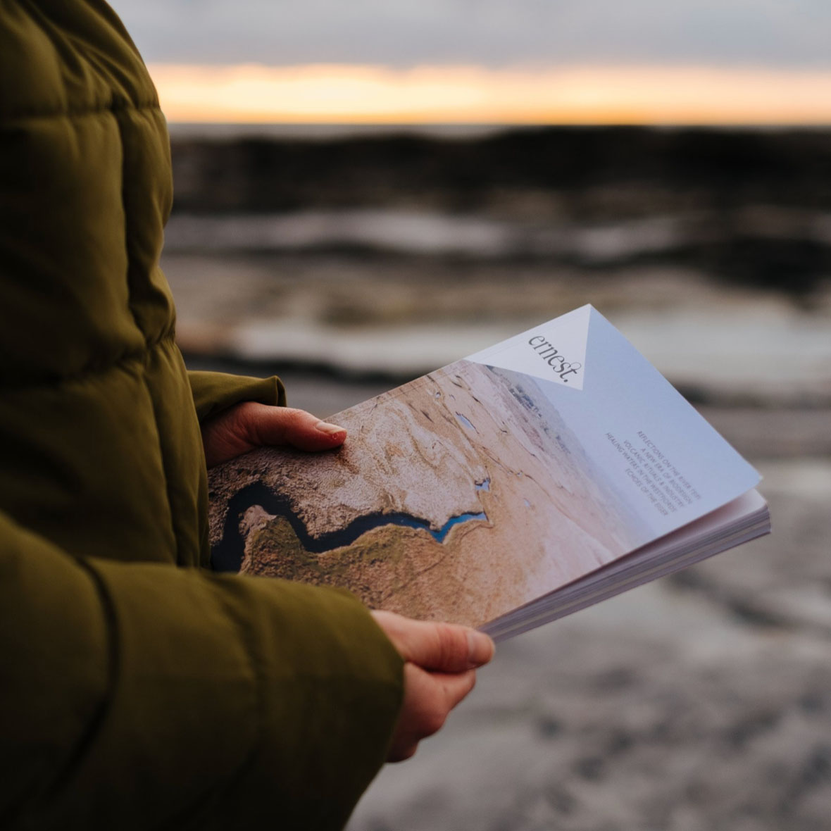 a woman holding a copy of Ernest journal, a magazinesthat inspire slow and seasonal living