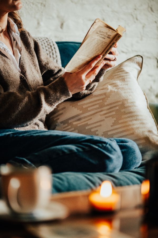 people sitting at a beautifully decorated table with candles glowing