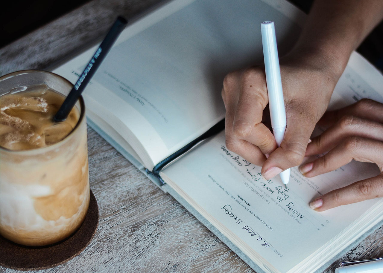 a woman on a bed with a laptop, holding a cup of coffee - next steps to future-proof your small business