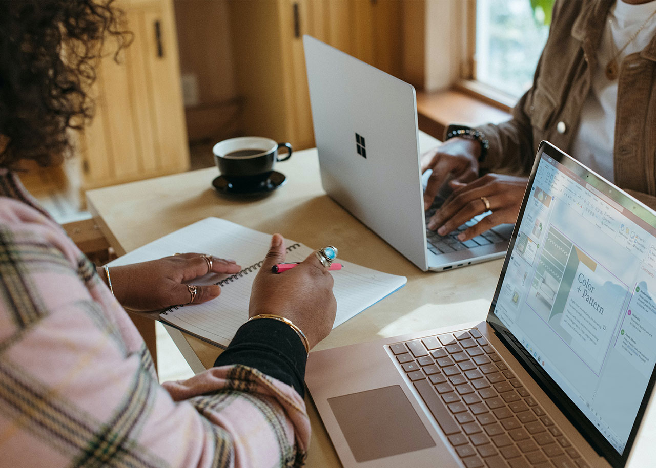 a woman on a bed with a laptop, holding a cup of coffee - next steps to future-proof your small business