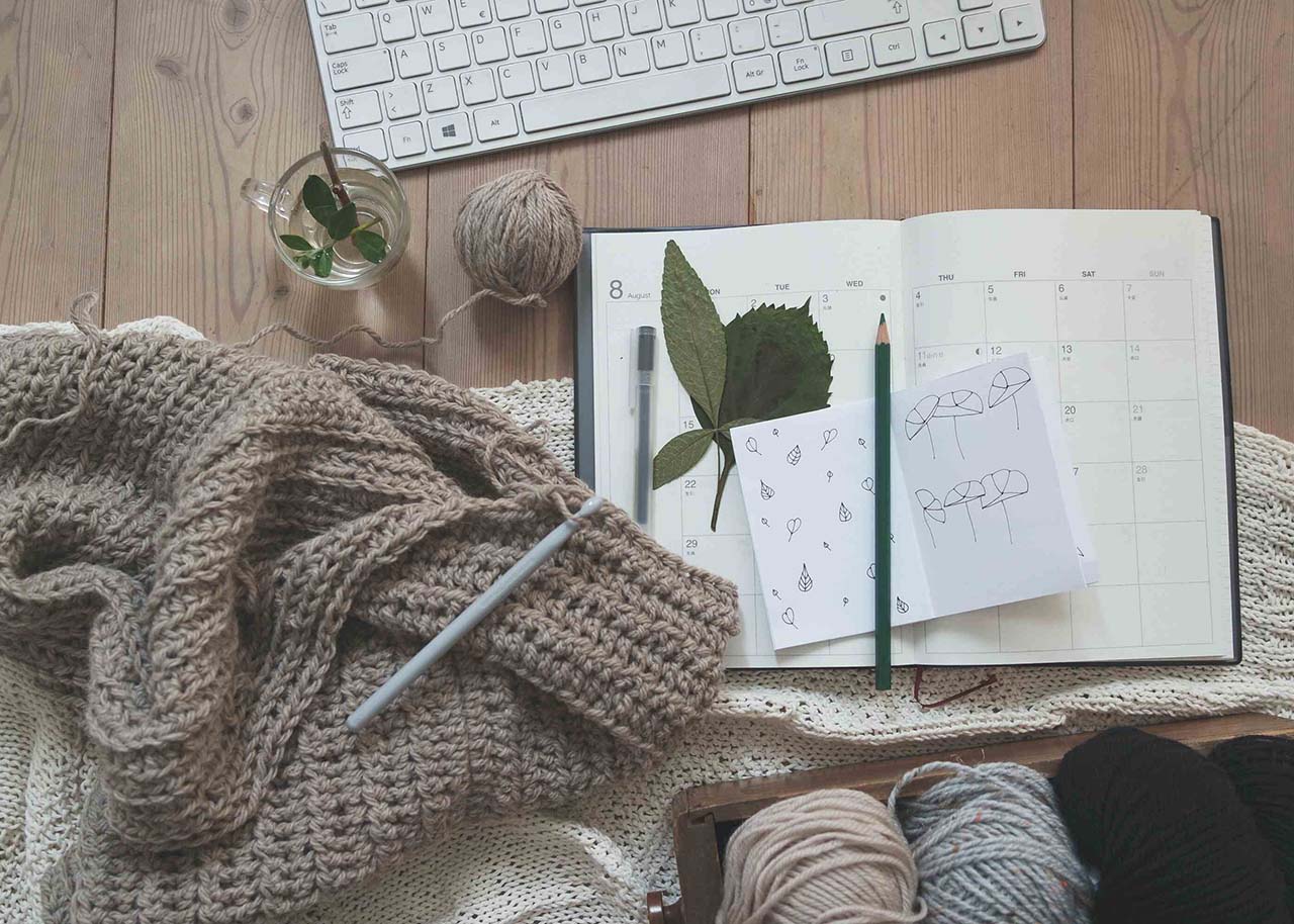 a woman on a bed with a laptop, holding a cup of coffee - next steps to future-proof your small business