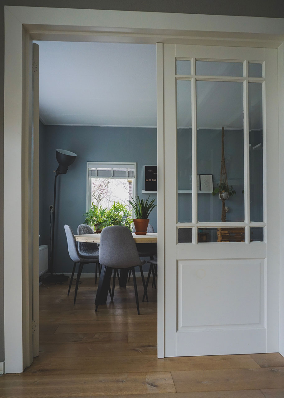 a view of a living room through a door with glass - how to increase natural light in your home