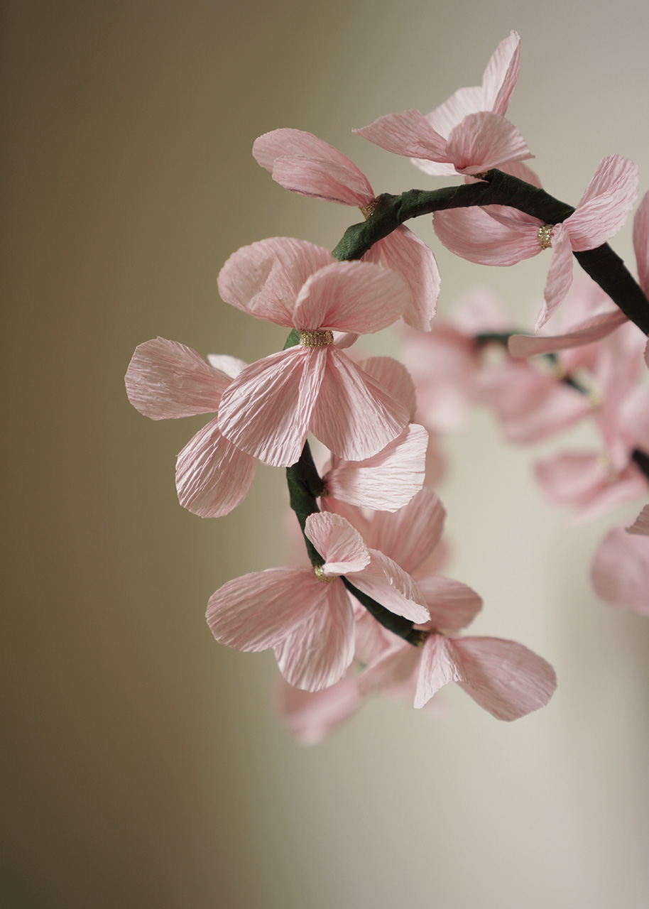 a branch with paper flowers attached to it - spring creativity ideas