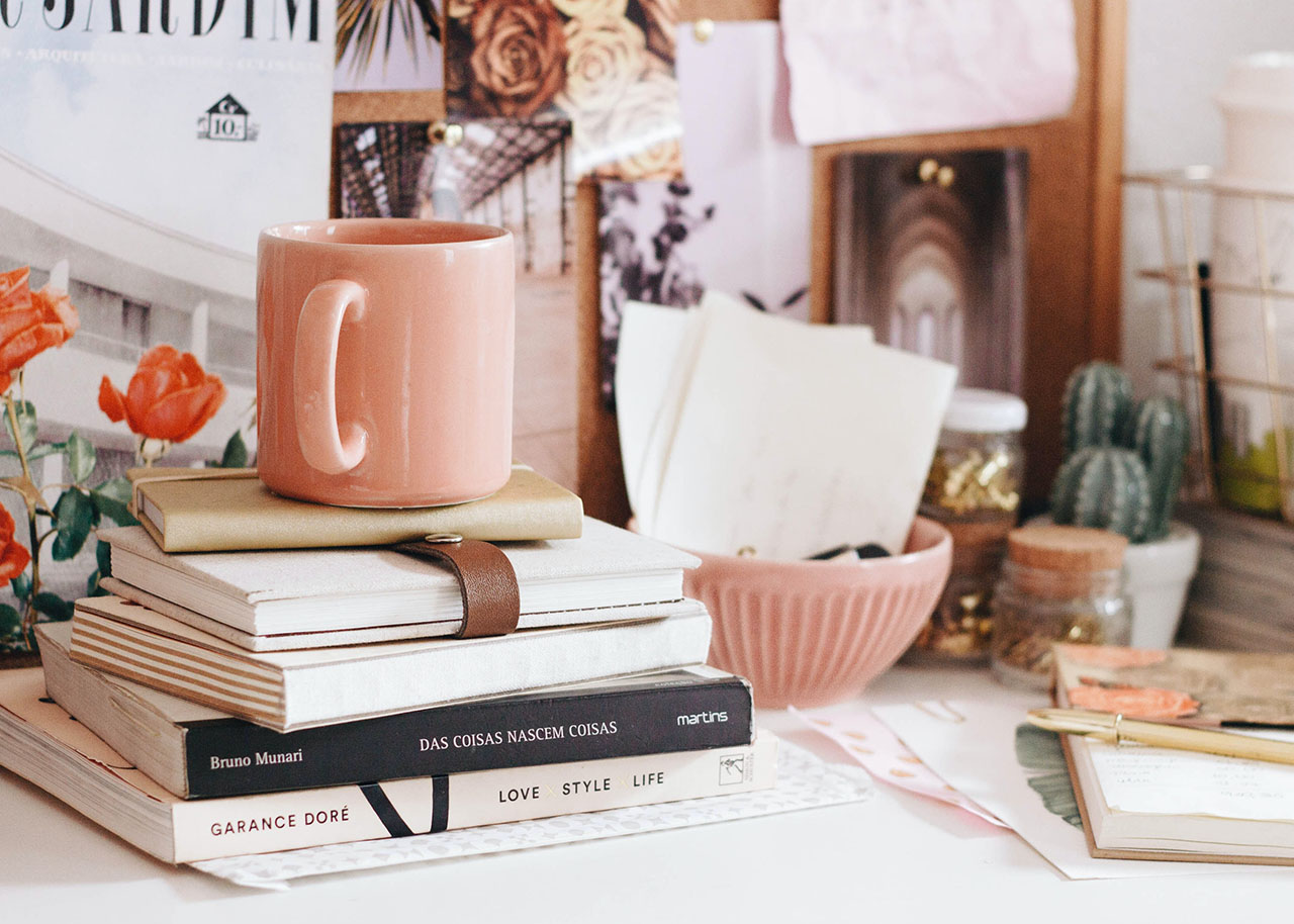 a woman on a bed with a laptop, holding a cup of coffee - next steps to future-proof your small business