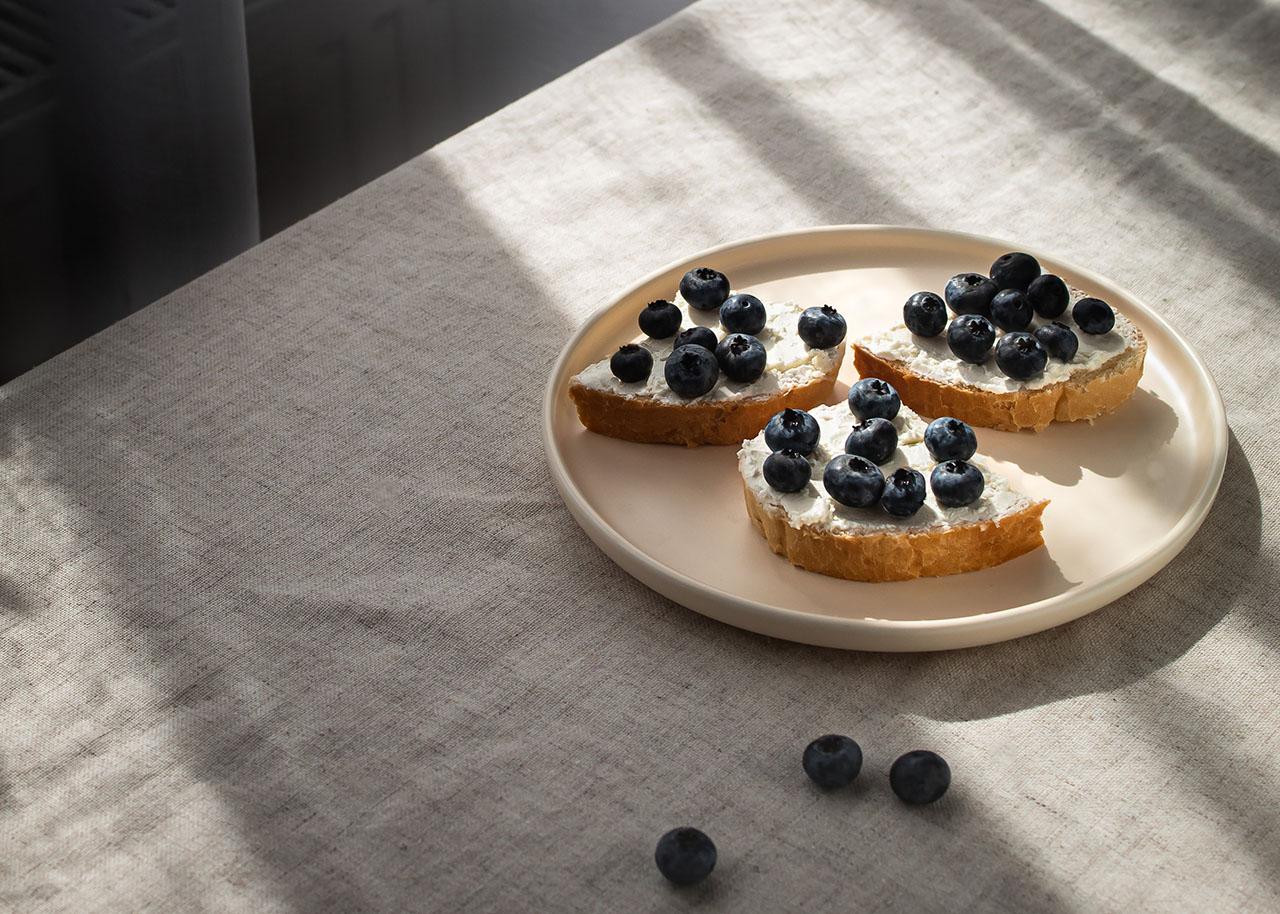plate with toast and blueberries on a table