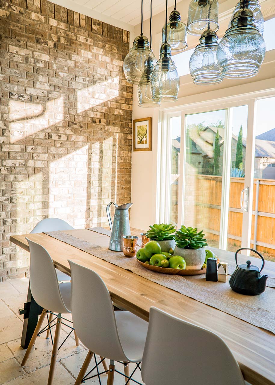 a cosy kitchen with large windows and the sun shining in - designing a warm and welcoming kitchen