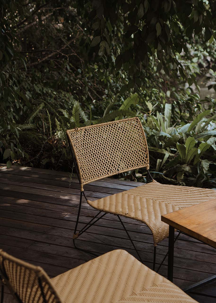two low garden chairs on a wooden patio - eco-friendly furniture