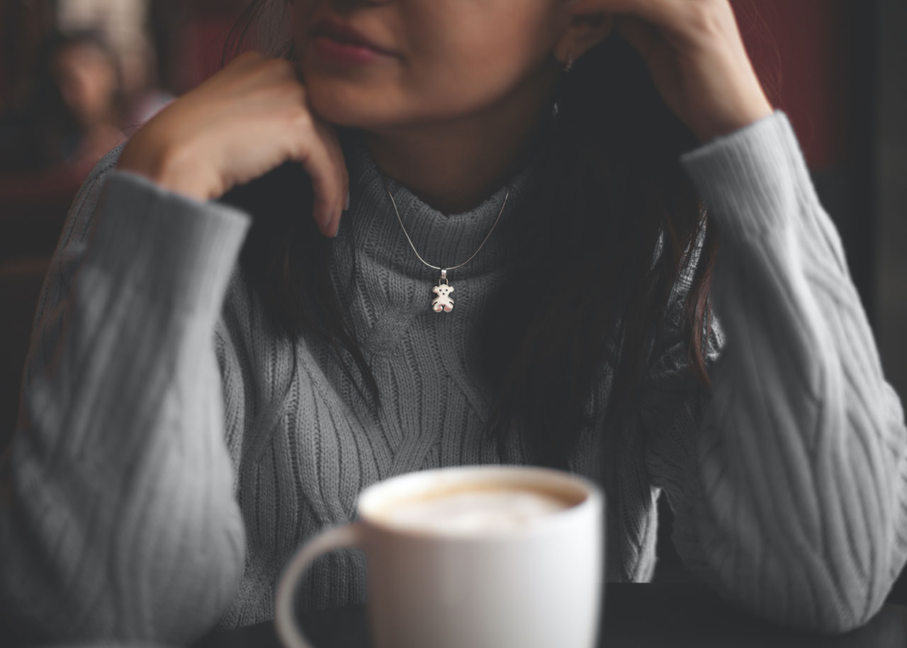 a woman on a bed with a laptop, holding a cup of coffee - next steps to future-proof your small business