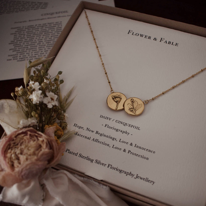 a gold double coin necklace with flowers from Flower & Fable