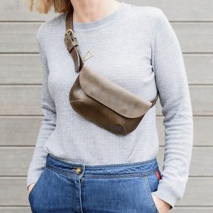 woman wearing a tanned leather belt bag from Red Bike Leatherworks