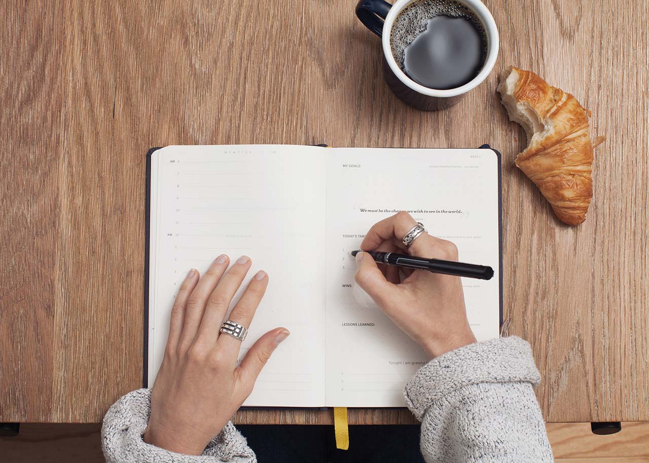 a woman on a bed with a laptop, holding a cup of coffee - next steps to future-proof your small business