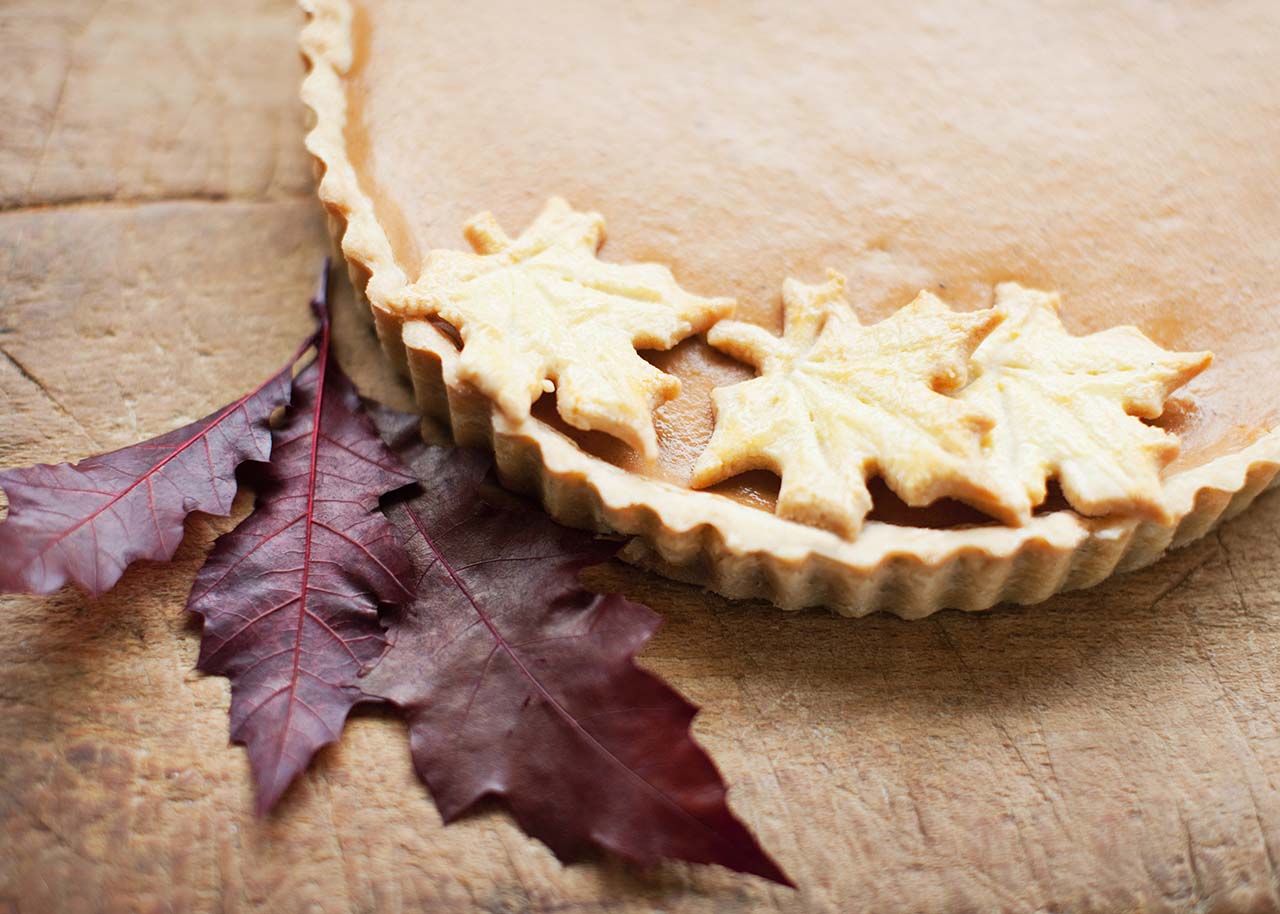 a seasonal pie adorned with autumn leaves