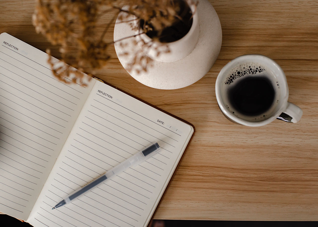 a woman on a bed with a laptop, holding a cup of coffee - next steps to future-proof your small business