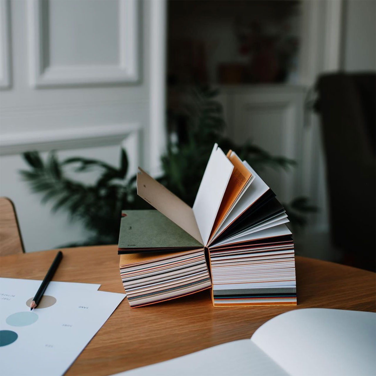 open book with colour samples on a table - slow branding