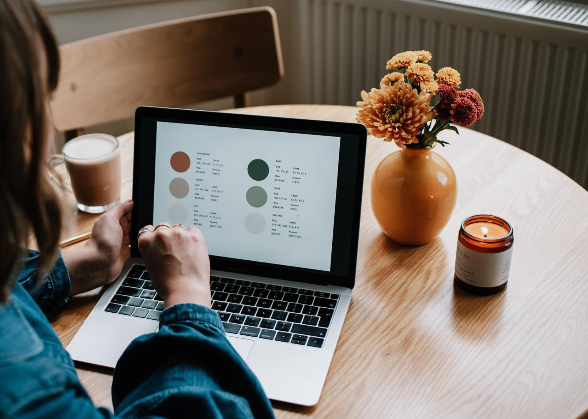 a woman on a bed with a laptop, holding a cup of coffee - next steps to future-proof your small business