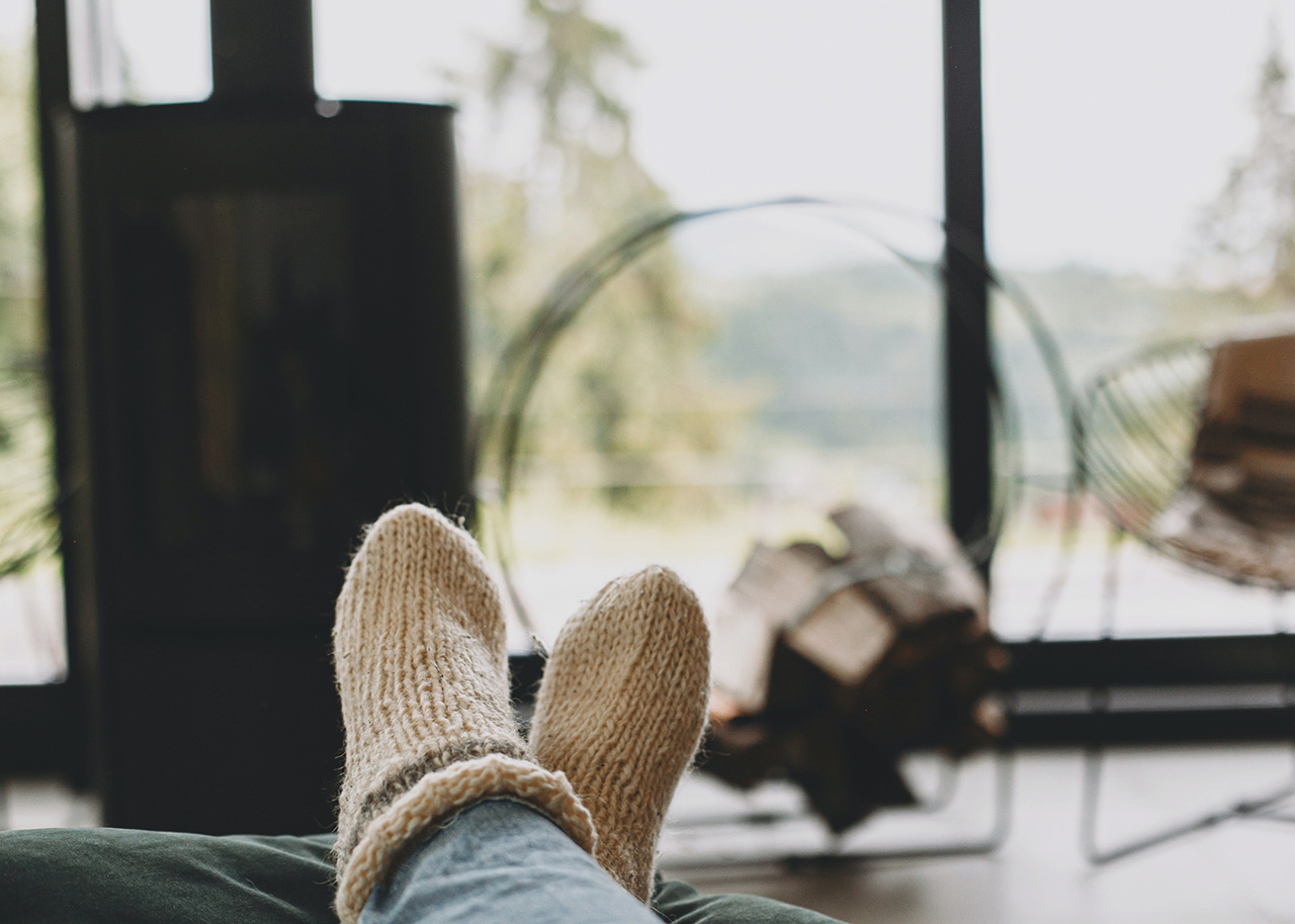 a woman on a bed with a laptop, holding a cup of coffee - next steps to future-proof your small business