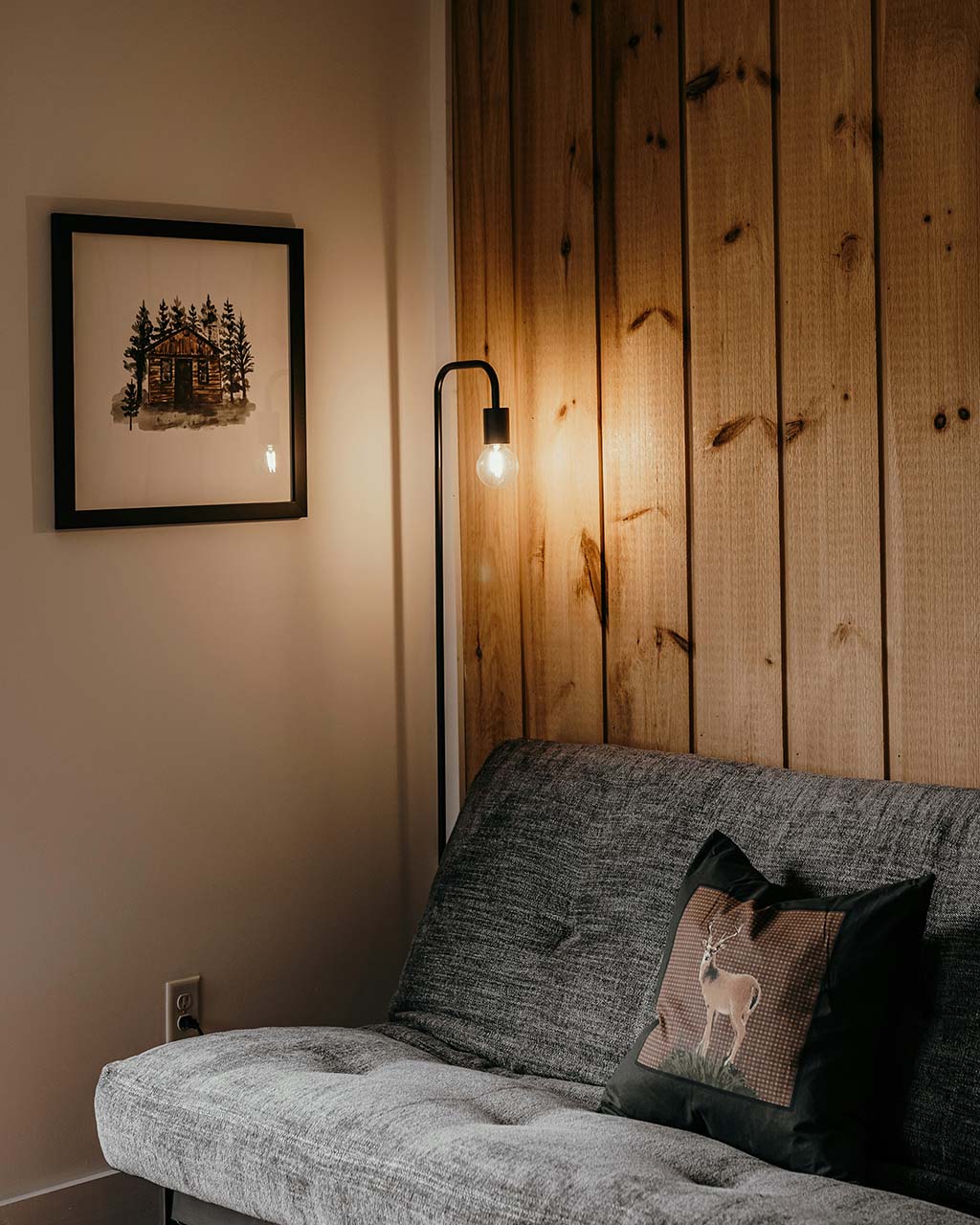 a lamp next to a cosy couch - how to optimise lighting in your home