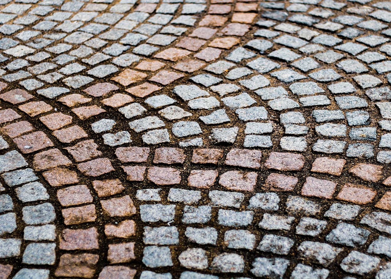 granite setts in grey and pink in a curved motif