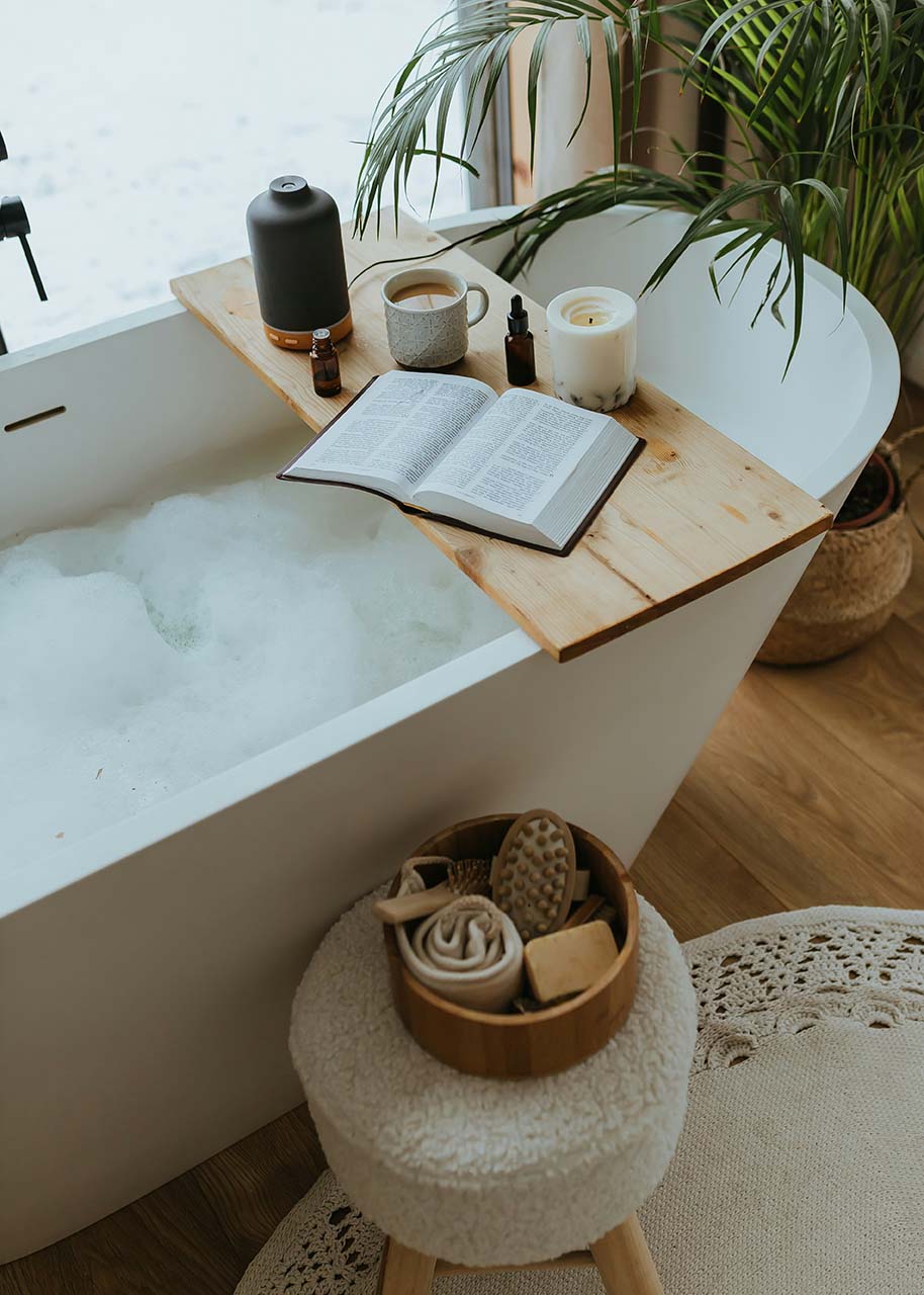 a foamy bath with candles, coffee, a book and some self-care tools - self-care tips