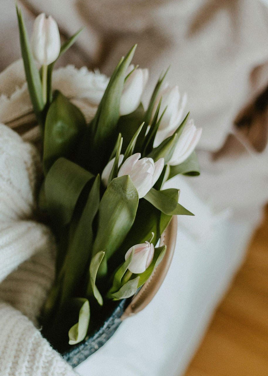 a bouquet of tulips in a bag with a cosy wool sweater - flowers and slow living