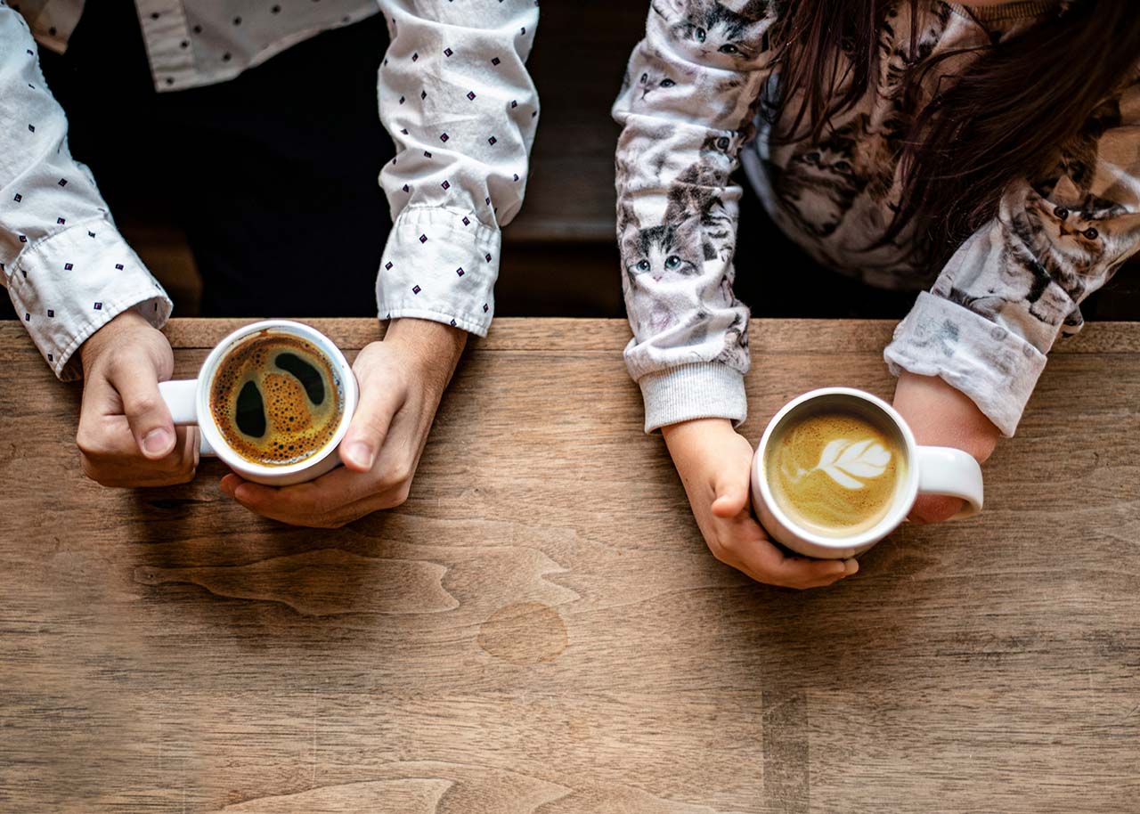 a woman on a bed with a laptop, holding a cup of coffee - next steps to future-proof your small business