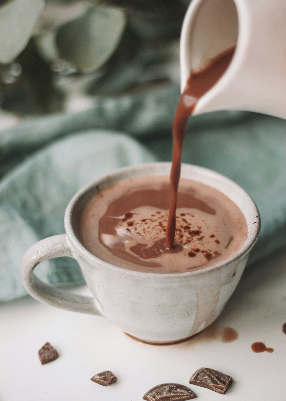 Hot chocolate and self-care chocolate being poured in a cup - chocolate and self-care
