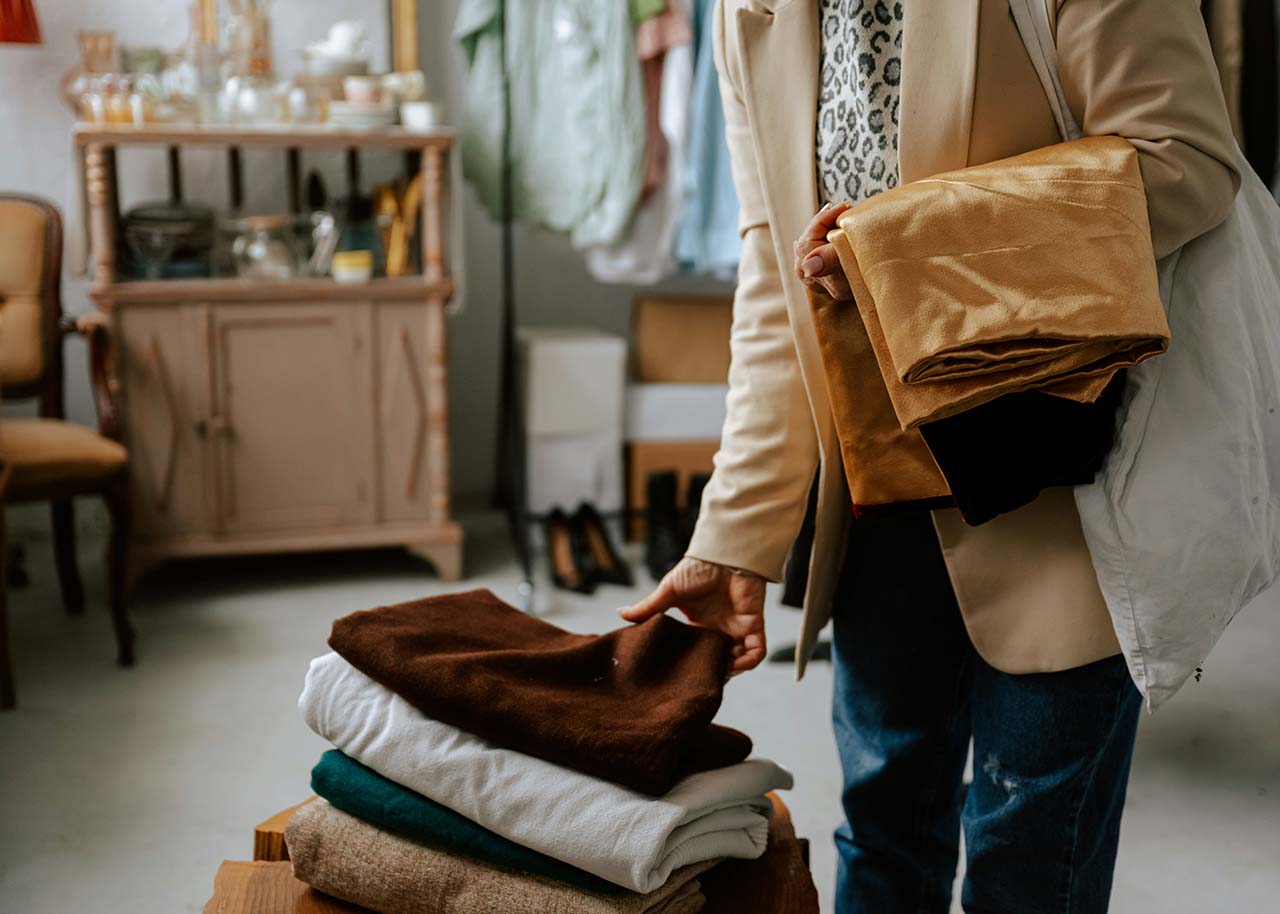 Letting go of clutter a woman sorting clothes - letting go of clutter