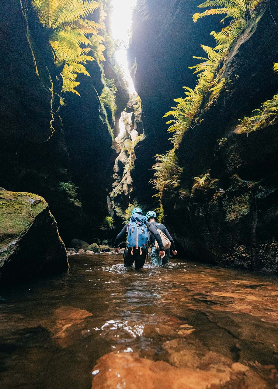 Mindful travel - adventure two people walking through a canyon - mindful travel - balance relaxation and adventure