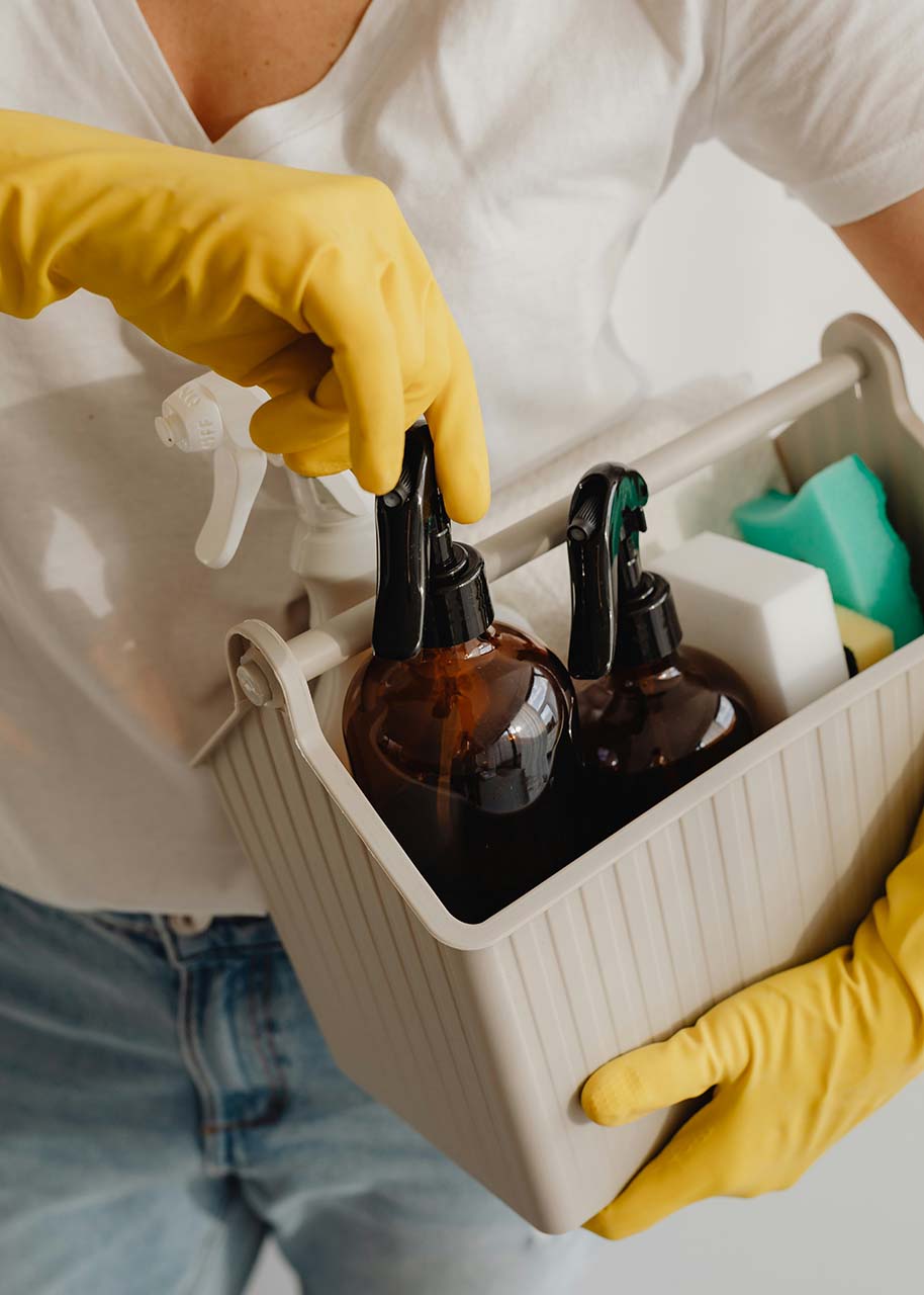 Outsourcing commercial cleaning a woman holding cleaning supplies - Outsourcing commercial cleaning