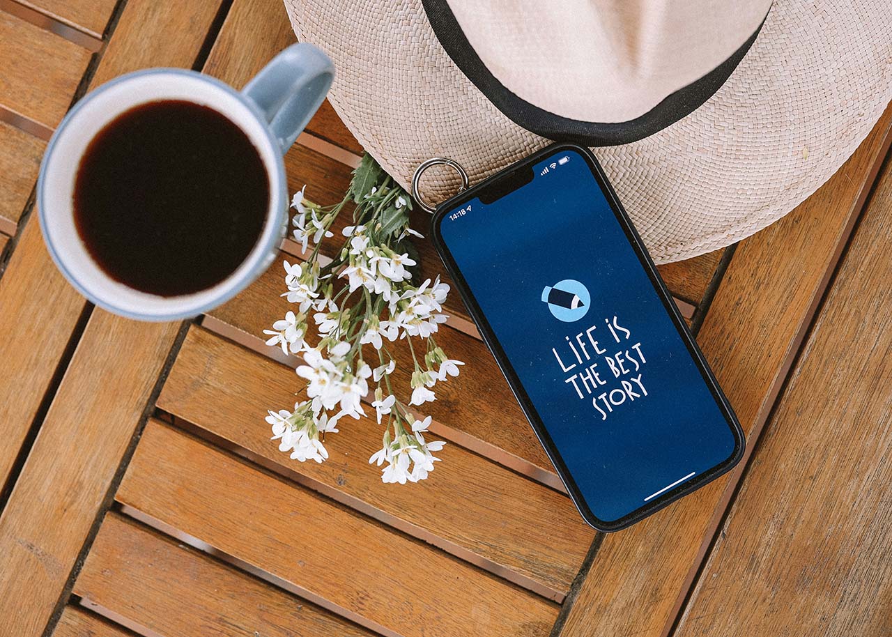 a woman on a bed with a laptop, holding a cup of coffee - next steps to future-proof your small business